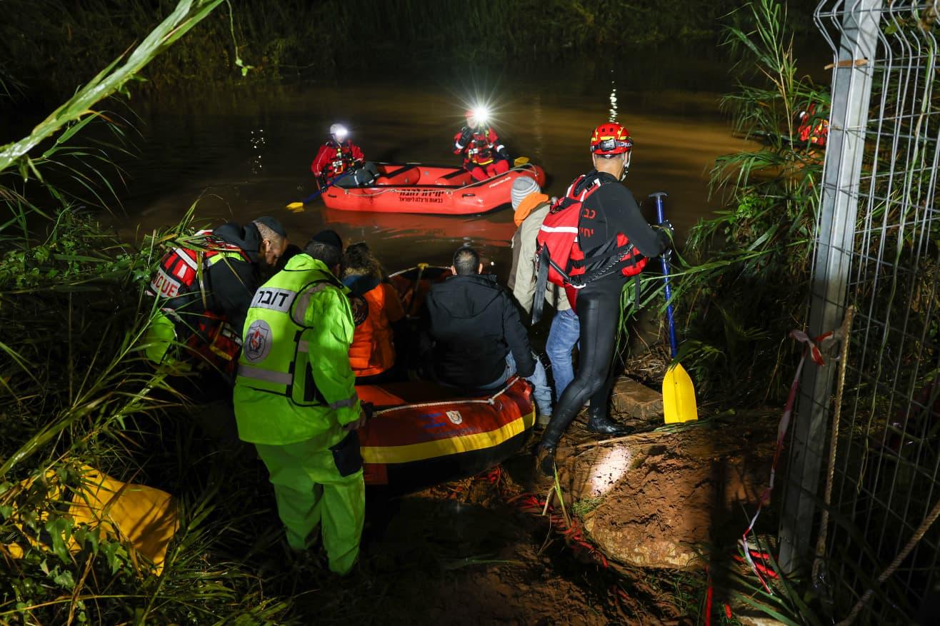 ZAKA volunteers working a night water rescue by headlamp.
