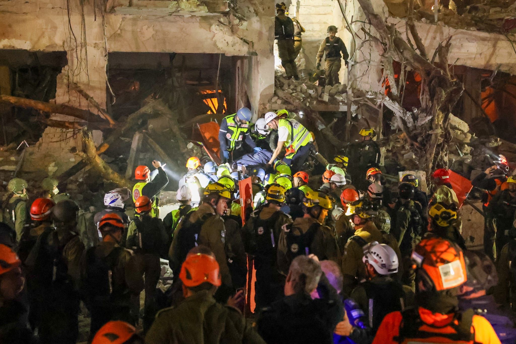 ZAKA volunteers work a scene by headlamp late into the night.