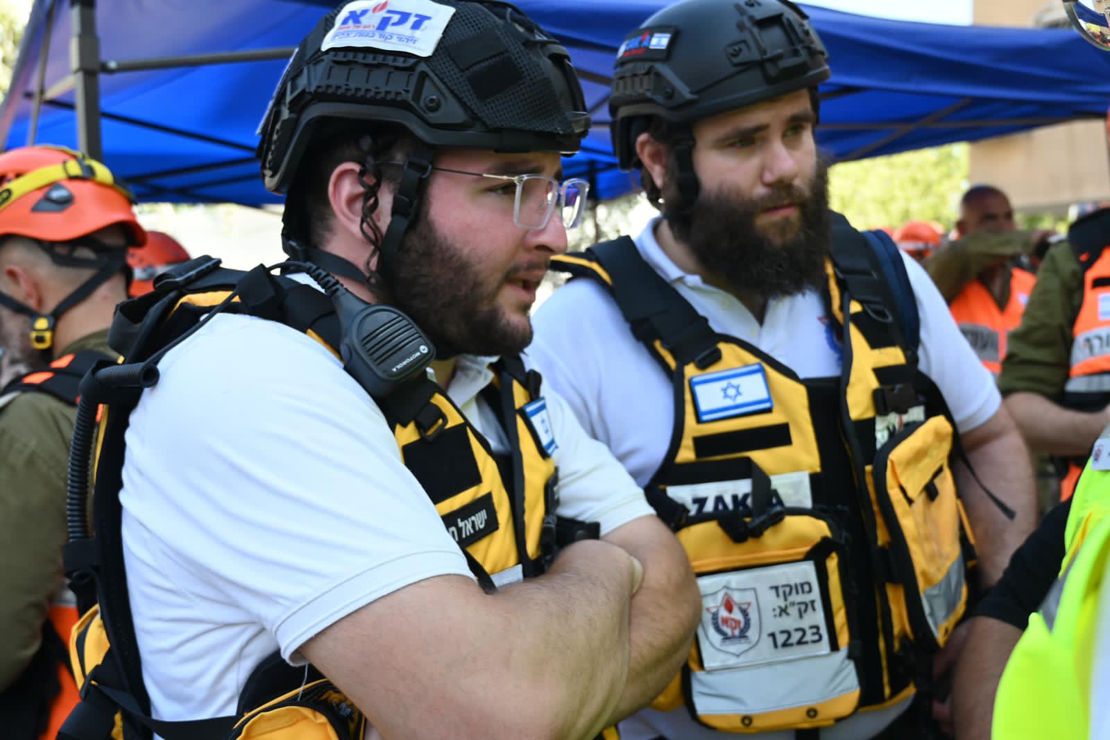Two ZAKA Tel Aviv volunteers in helmets and vests, ready at a scene.