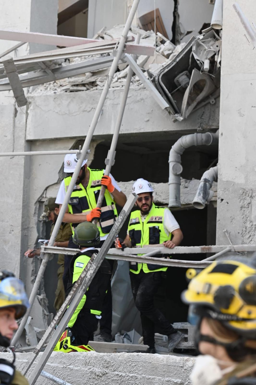 ZAKA volunteers search a collapsed building.