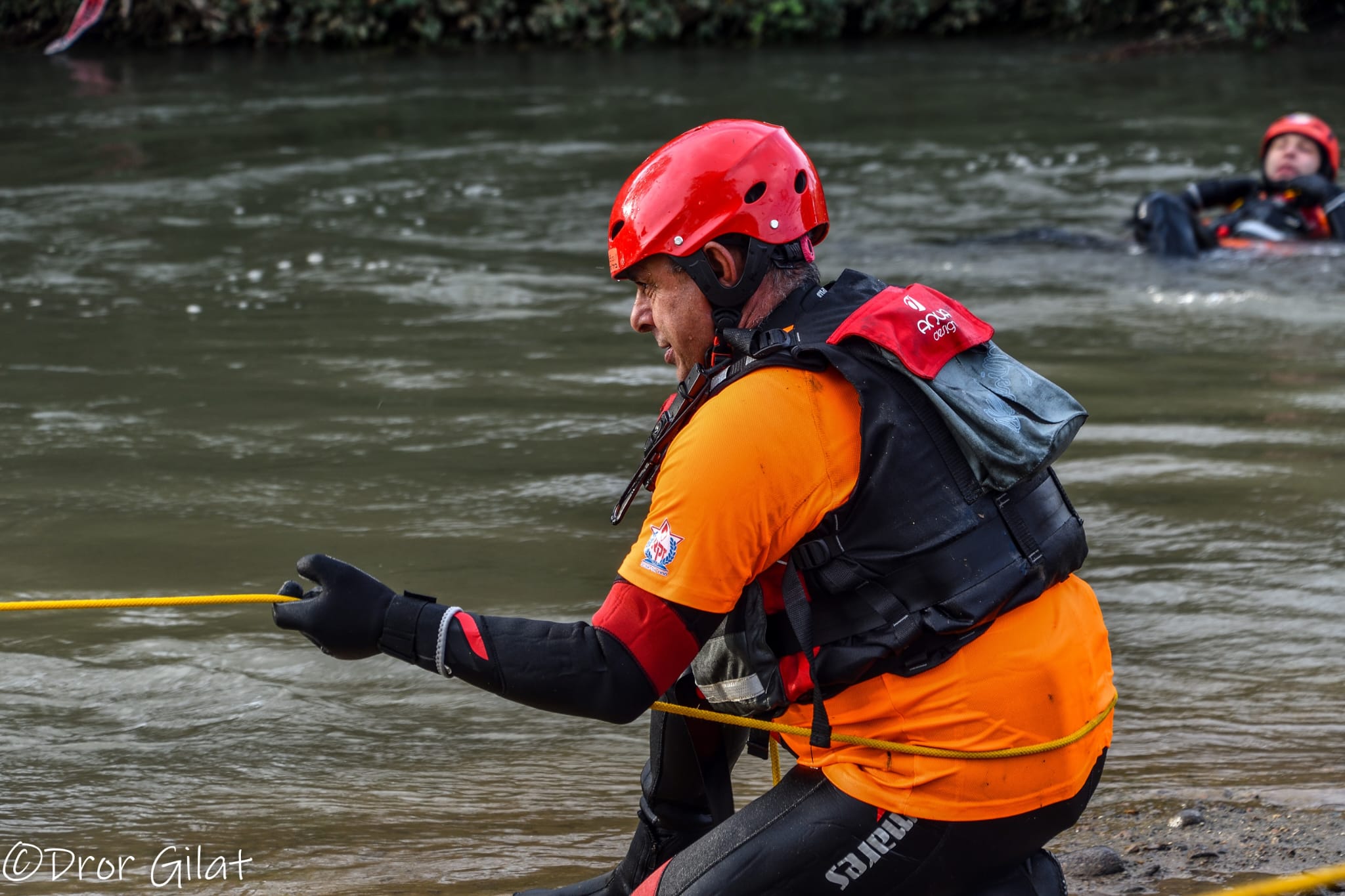 A ZAKA rescue swimmer works a fast moving river.